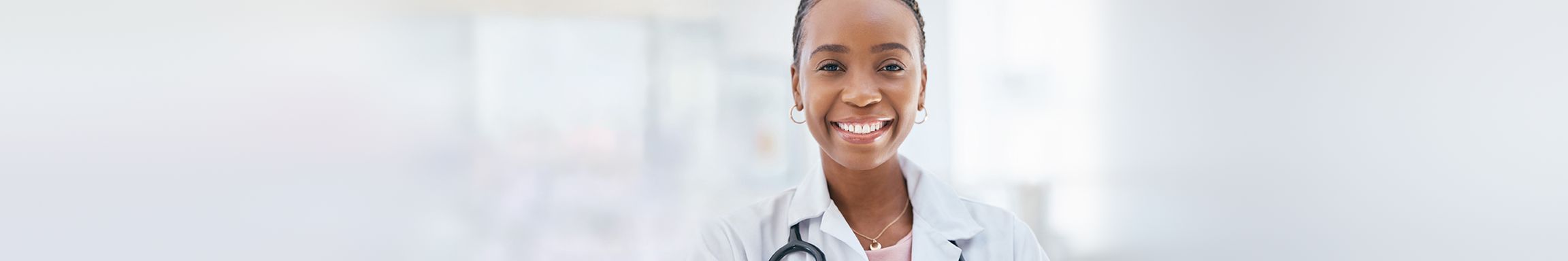 Smiling doctor in a white coat with a stethoscope