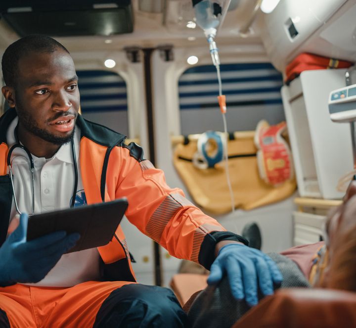 Paramedic with a tablet in an ambulance