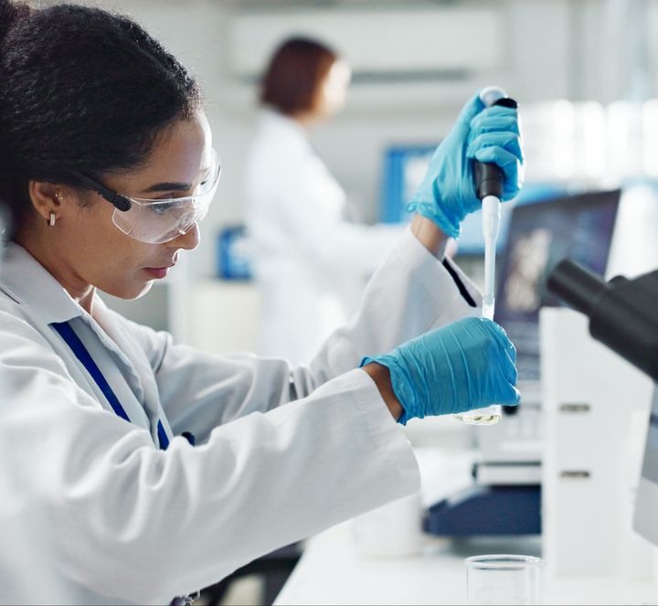 Medical technologist pipetting a sample in a laboratory