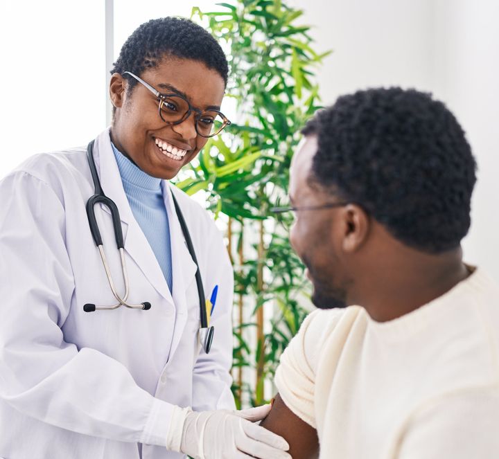 Smiling doctor talking with a patient